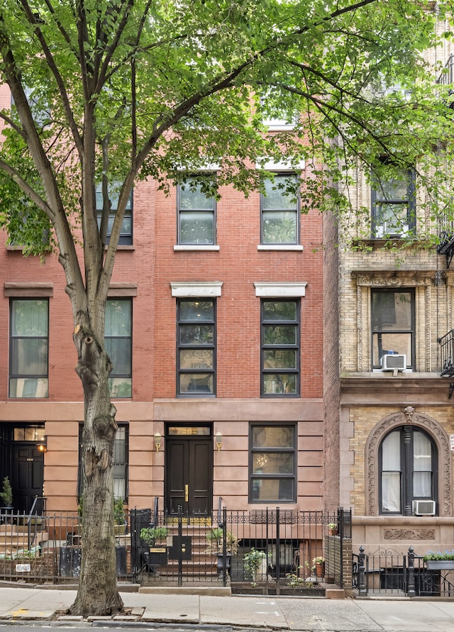 262 W 25th St, New York City, NY 10001 - view of building exterior featuring a fenced front yard and cooling unit