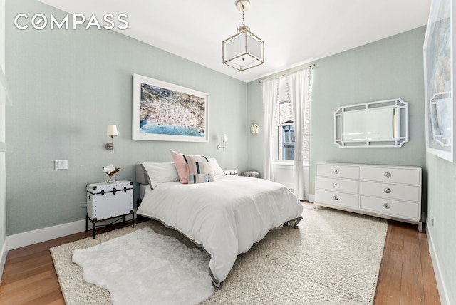 bedroom with wood finished floors and baseboards