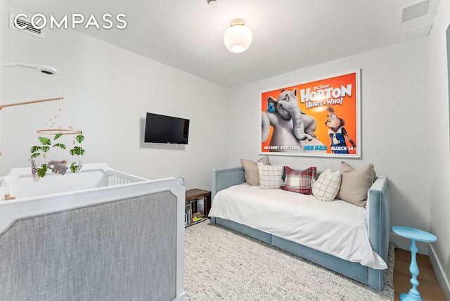 bedroom with baseboards and attic access