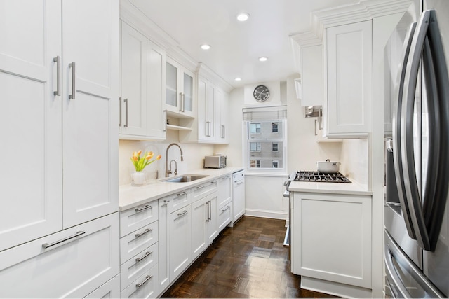 kitchen featuring stainless steel refrigerator with ice dispenser, a sink, white cabinetry, light countertops, and recessed lighting