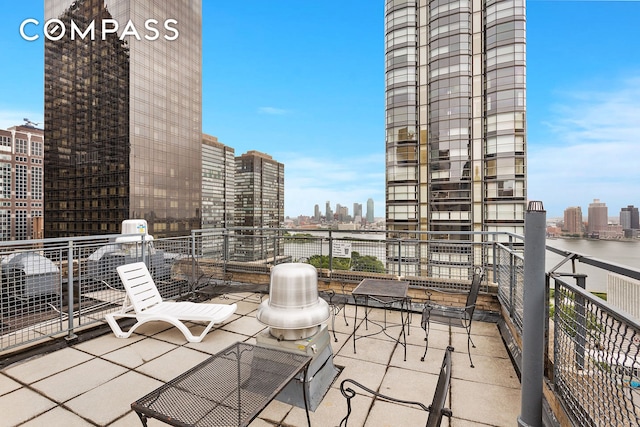 balcony with a view of skyline and a water view
