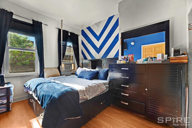 13 Suydam Place, New York City, NY 11233 - bedroom featuring wood finished floors, cooling unit, and baseboards