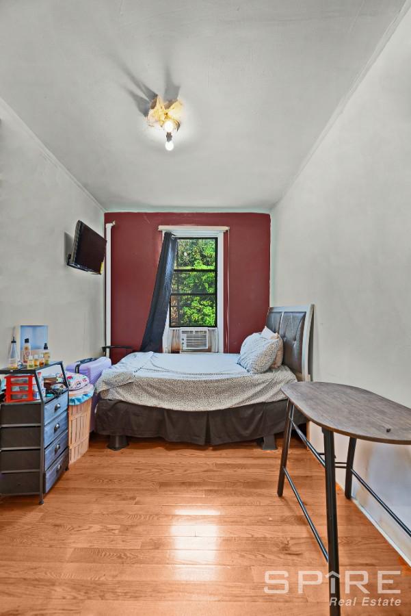 13 Suydam Place, New York City, NY 11233 - bedroom featuring wood finished floors and cooling unit