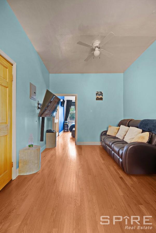 13 Suydam Place, New York City, NY 11233 - living area with ceiling fan, wood finished floors, and baseboards
