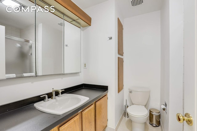 35 E 12th St Unit 8C, New York City, NY 10003 - bathroom featuring vanity, toilet, a shower with shower door, and baseboards