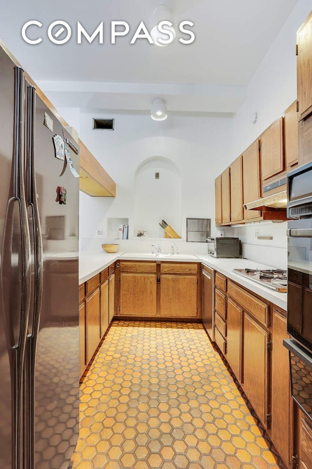 35 E 12th St Unit 8C, New York City, NY 10003 - kitchen featuring stainless steel appliances, light countertops, under cabinet range hood, a warming drawer, and a sink
