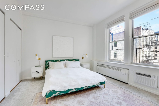 35 E 12th St Unit 8C, New York City, NY 10003 - bedroom with radiator, a wall mounted air conditioner, and carpet flooring