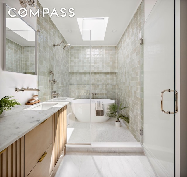 151 Chauncey St, New York City, NY 11233 - bathroom featuring tile walls, a stall shower, a skylight, a soaking tub, and vanity