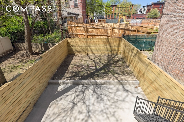 151 Chauncey St, New York City, NY 11233 - wooden deck featuring a fenced backyard and a patio