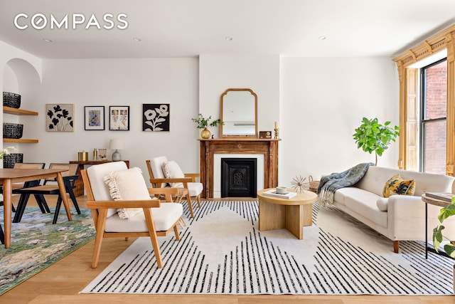 151 Chauncey St, New York City, NY 11233 - living room featuring wood finished floors and a fireplace