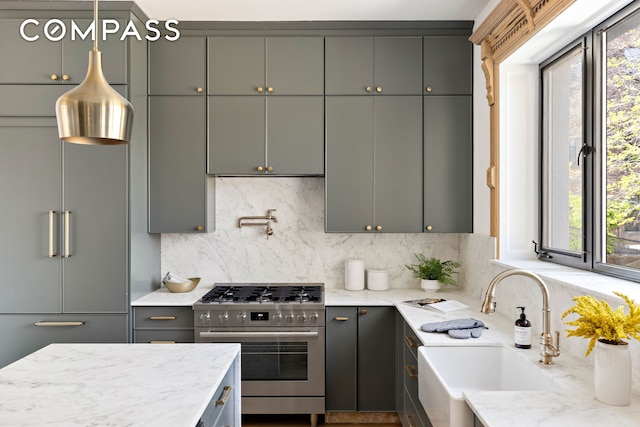151 Chauncey St, New York City, NY 11233 - kitchen featuring stainless steel gas stove, a sink, high end fridge, and decorative backsplash