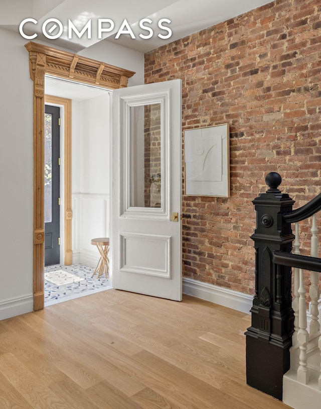 151 Chauncey St, New York City, NY 11233 - entryway with baseboards, wood finished floors, and brick wall