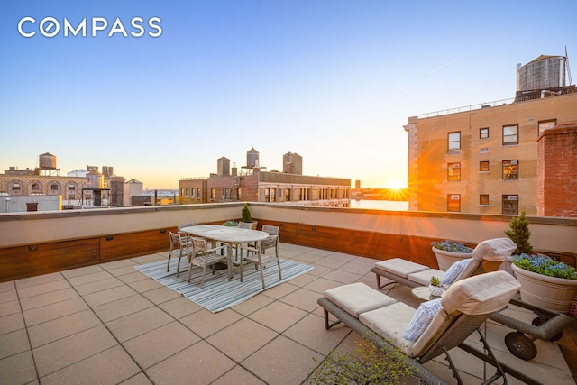 view of patio with a view of city and outdoor dining area
