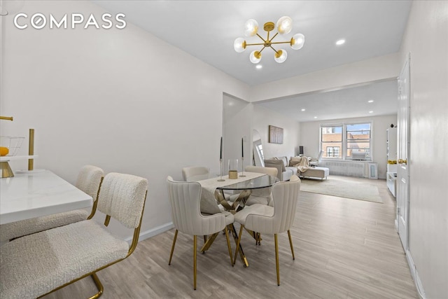 dining space featuring a chandelier, light wood-type flooring, baseboards, and recessed lighting