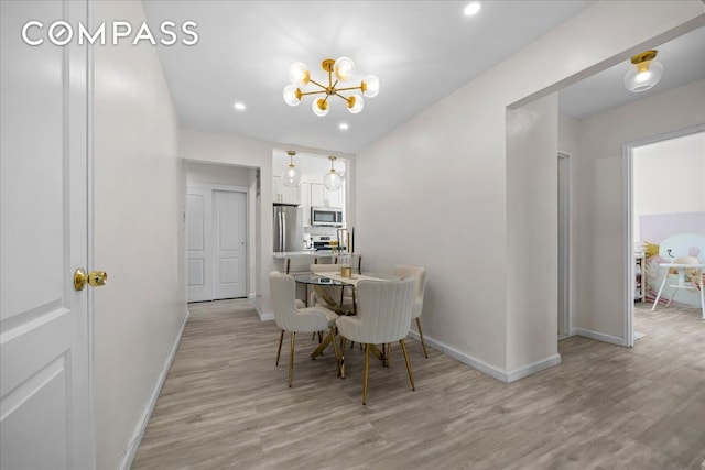 dining area with baseboards, a chandelier, light wood-type flooring, and recessed lighting