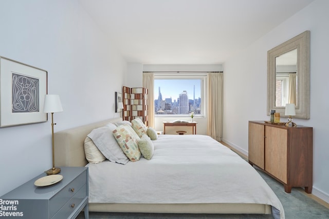 carpeted bedroom featuring baseboards