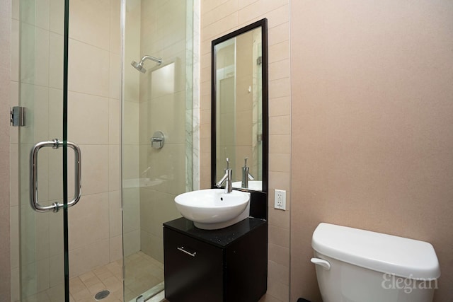 full bath featuring a shower stall, vanity, and toilet