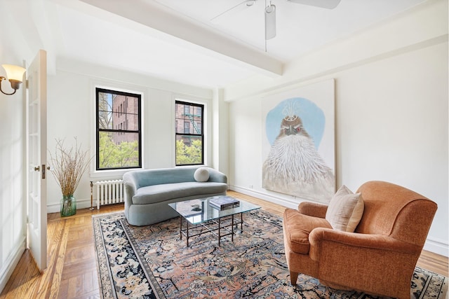 141 E 3rd St Unit 3H, New York City, NY 10009 - living room featuring radiator heating unit, ceiling fan, beamed ceiling, and baseboards