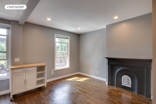 unfurnished living room with dark wood-style floors, baseboards, recessed lighting, and a fireplace