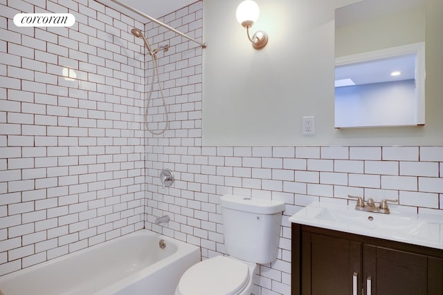 bathroom featuring toilet, shower / bath combination, vanity, tile walls, and tasteful backsplash
