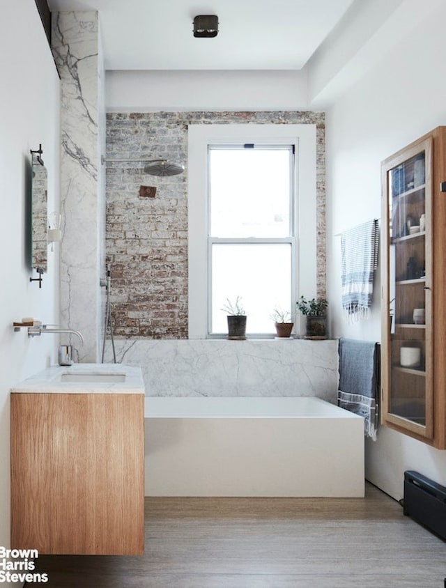 135 Hudson St Unit 6F, New York City, NY 10013 - full bathroom with a bathtub, vanity, and wood finished floors