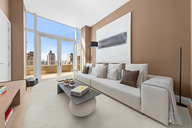 living area with a city view, a wall of windows, and carpet flooring