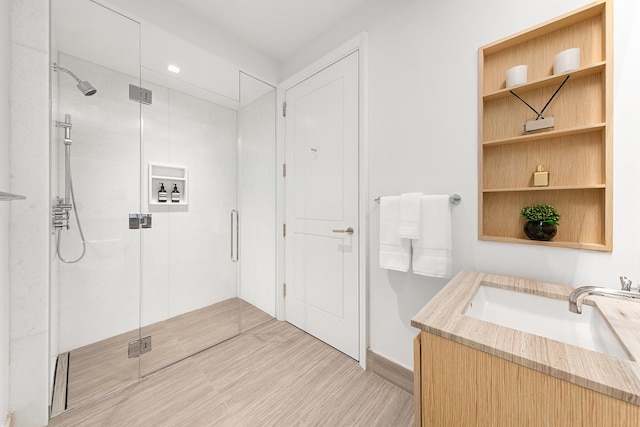 full bathroom with a shower stall and vanity