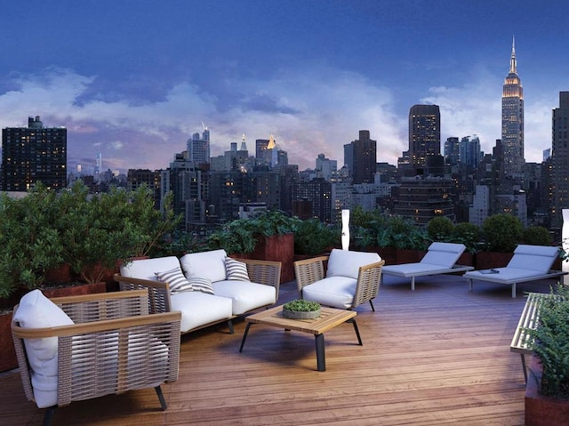 wooden terrace with outdoor lounge area and a view of skyline