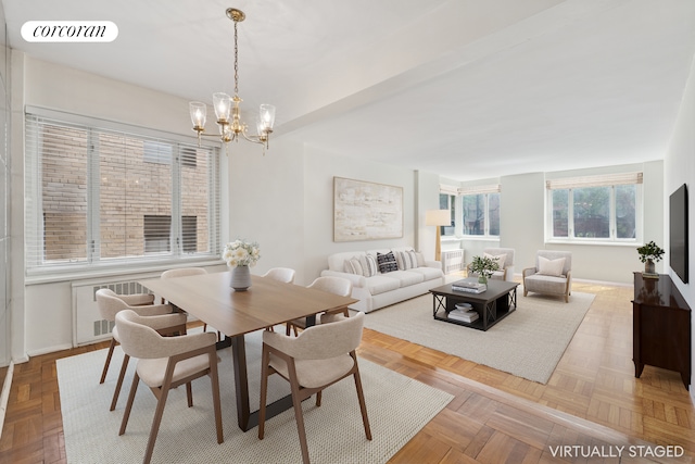 36 Sutton Pl S Unit 2A, New York City, NY 10022 - dining room with a chandelier, baseboards, and radiator heating unit