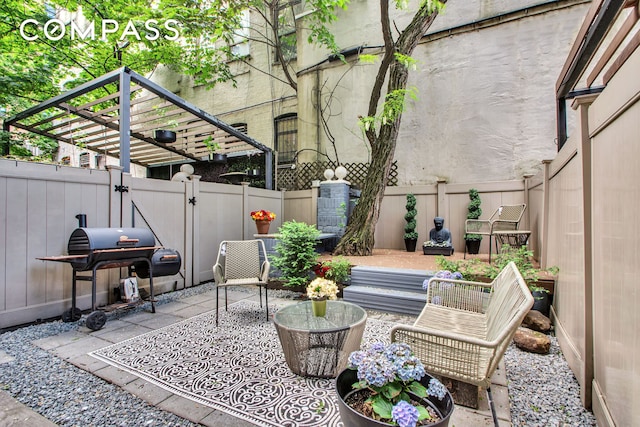 view of patio / terrace with a grill, a gate, and a fenced backyard