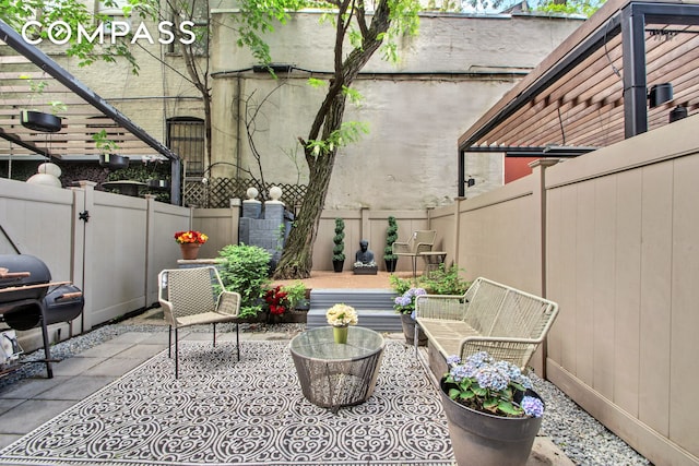 view of patio / terrace with a fenced backyard and area for grilling