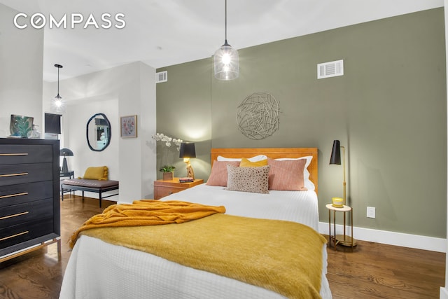 bedroom featuring baseboards and wood finished floors
