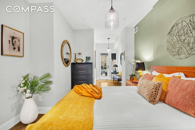 bedroom with wood finished floors and baseboards