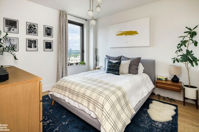 22-18 Jackson Ave Unit 801, New York City, NY 11101 - bedroom featuring baseboards and wood finished floors