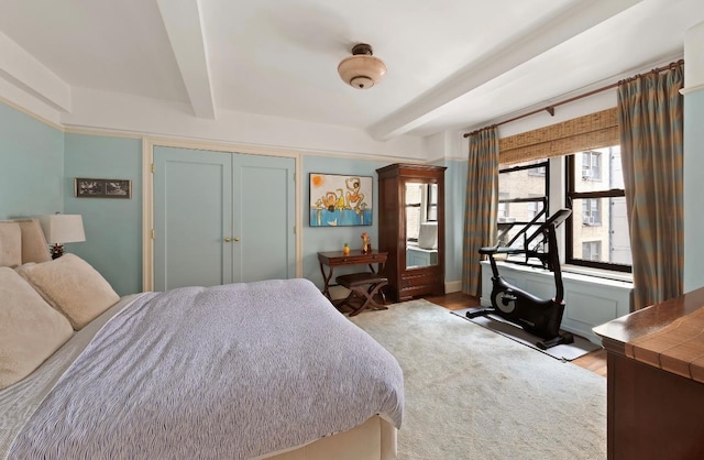 205 E 78th St Unit 12J, New York City, NY 10021 - bedroom with beam ceiling, wood finished floors, and a closet