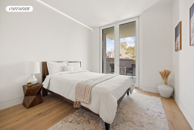 1110 Manhattan Ave Unit 2, New York City, NY 11222 - bedroom featuring access to exterior, expansive windows, and light wood-style flooring