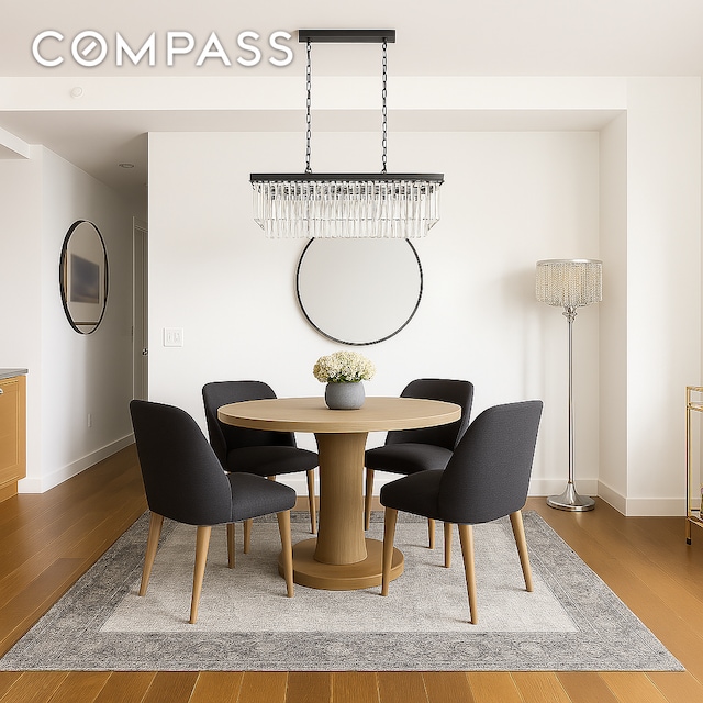 dining space featuring baseboards and wood finished floors
