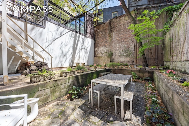 view of patio featuring fence