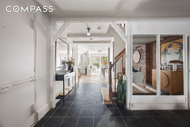 hallway with dark tile patterned flooring
