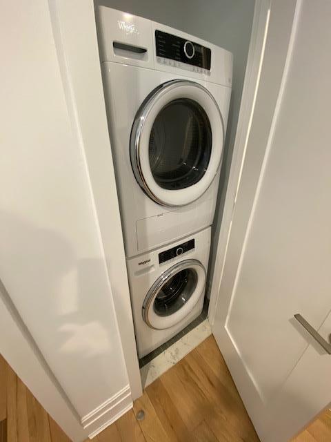 77 Clarkson Ave Unit 4-C, New York City, NY 11226 - washroom featuring estacked washer and dryer and wood finished floors