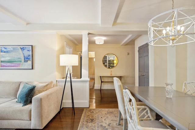 living room with dark wood-type flooring, a chandelier, and beam ceiling