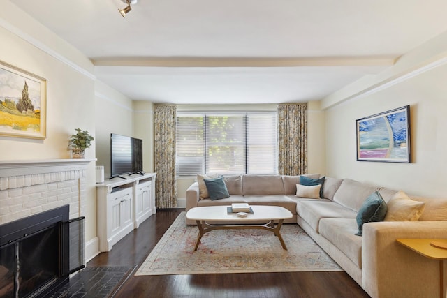 living area with dark wood-style floors, a fireplace, and beam ceiling