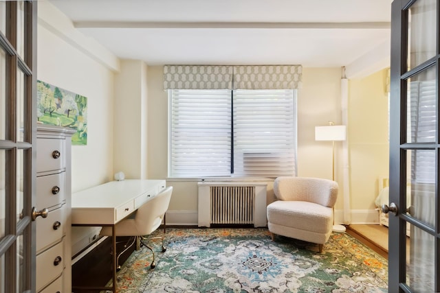 office with radiator, baseboards, and wood finished floors