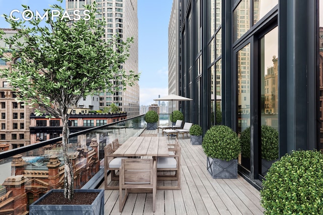 wooden terrace with outdoor dining area