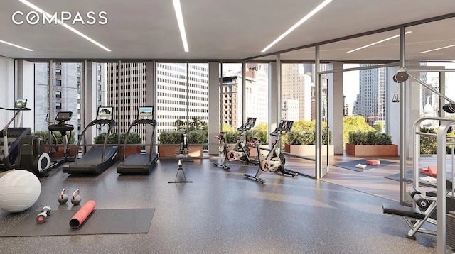 exercise room featuring a view of city and a wall of windows