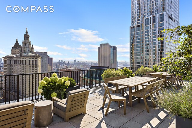 view of patio featuring a skyline view and outdoor dining space