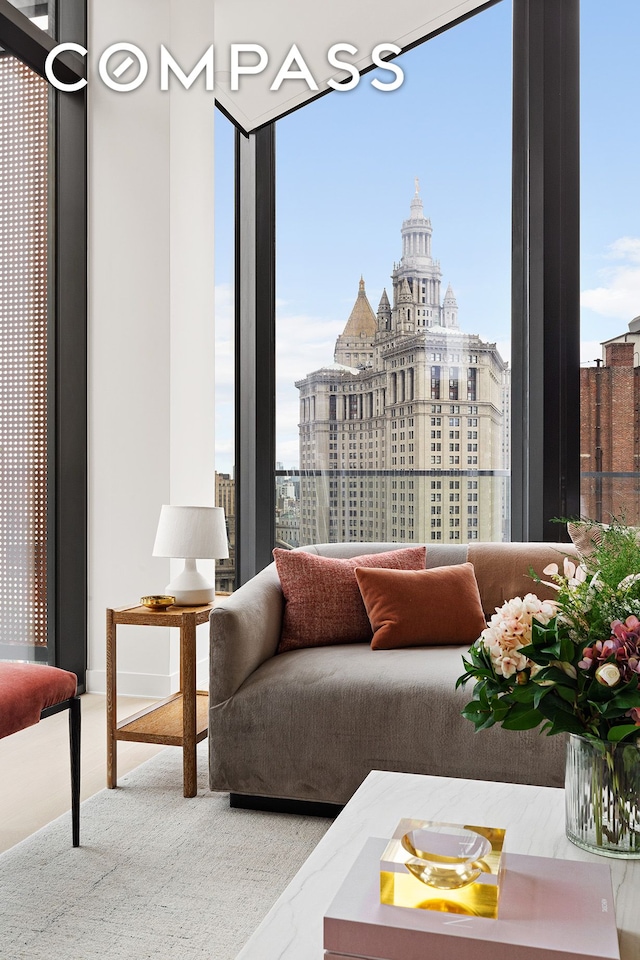living room featuring expansive windows, healthy amount of natural light, and a city view
