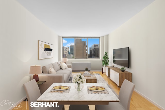 living area featuring light wood-style flooring and baseboards