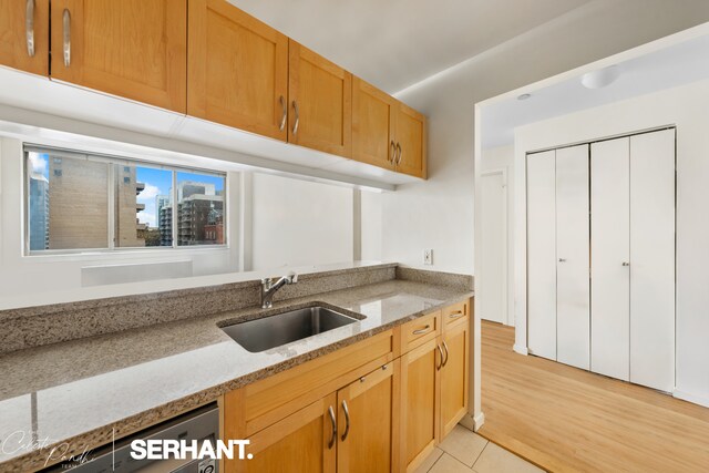 250 E 30th St Unit 8D, New York City, NY 10016 - kitchen featuring a sink, light stone countertops, and light wood finished floors