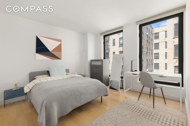 111 Montgomery St Unit 5R, New York City, NY 11225 - bedroom featuring an office area, multiple windows, and light wood-style floors